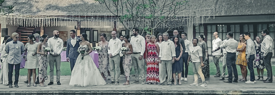 A Villa Tirtadari wedding party posing in front of a pool.